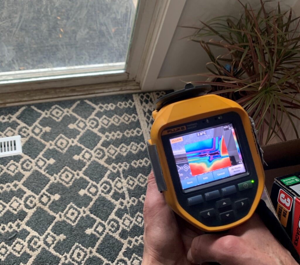 A thermal imaging camera is used to reveal insulation gaps during an energy assessment